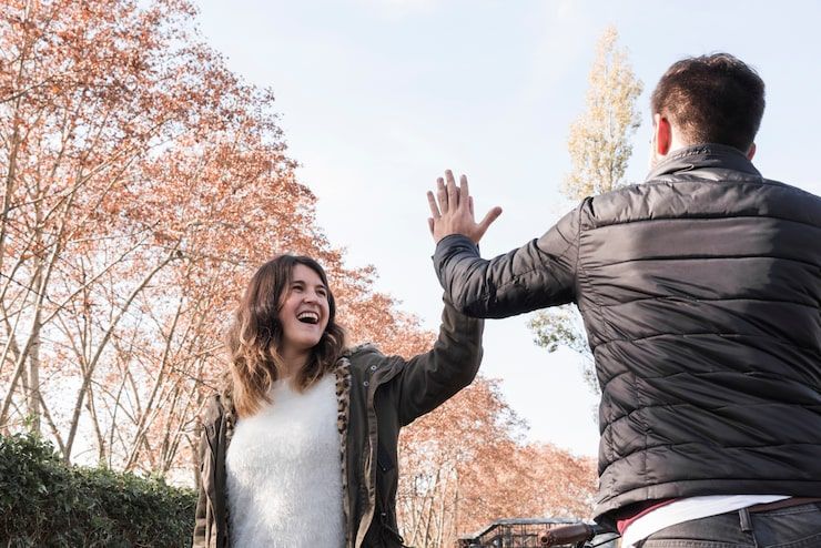 Two people greeting each other warmly